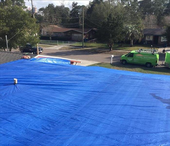 tarp on homeowners roof to protect against further water instrusion